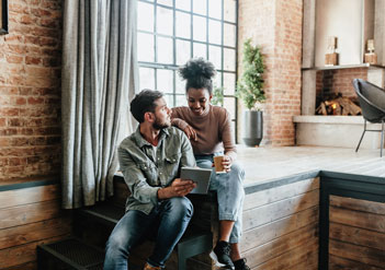 Couple looking at open enrollment insights on a tablet