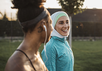 two-women-walking-and-smiling